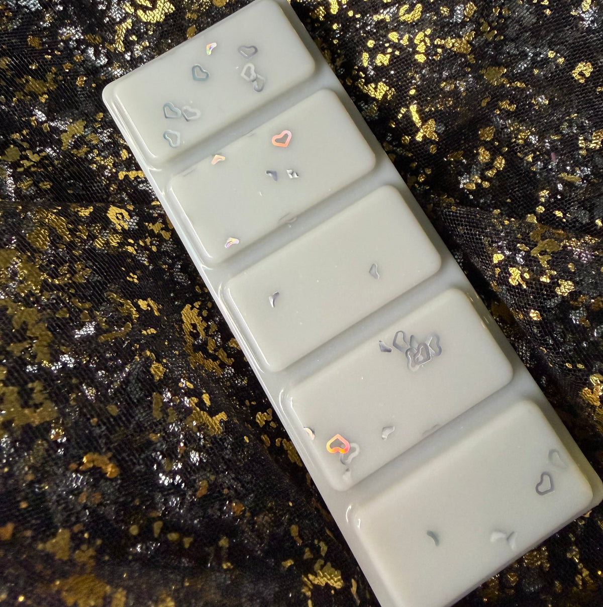 Close-up photograph of the Fallen Angel SoulMist-inspired wax melt showing the decoration across the five individual segments and part of the collaboration label.