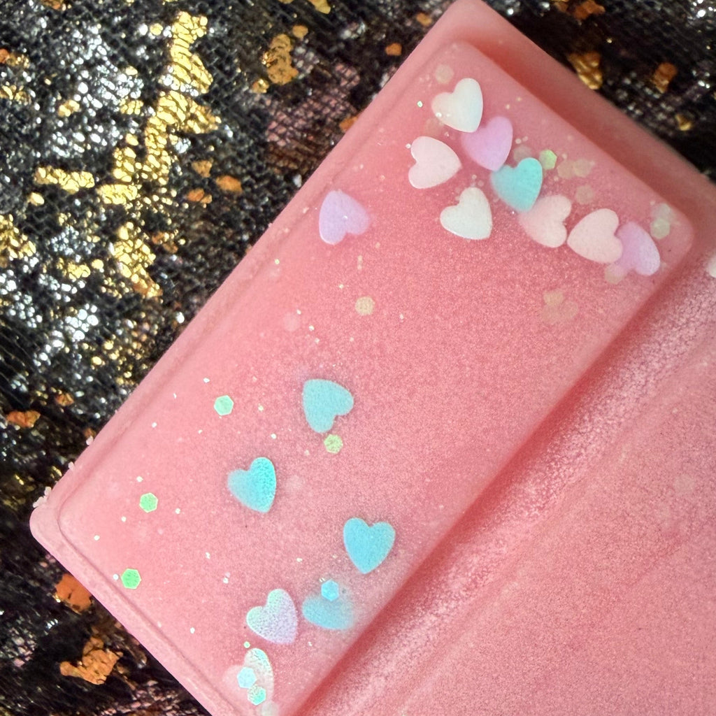 Close-up photograph of the Evangeline’s Enchantment wax melt showing the decoration across the individual segments and part of the romantasy-inspired label.