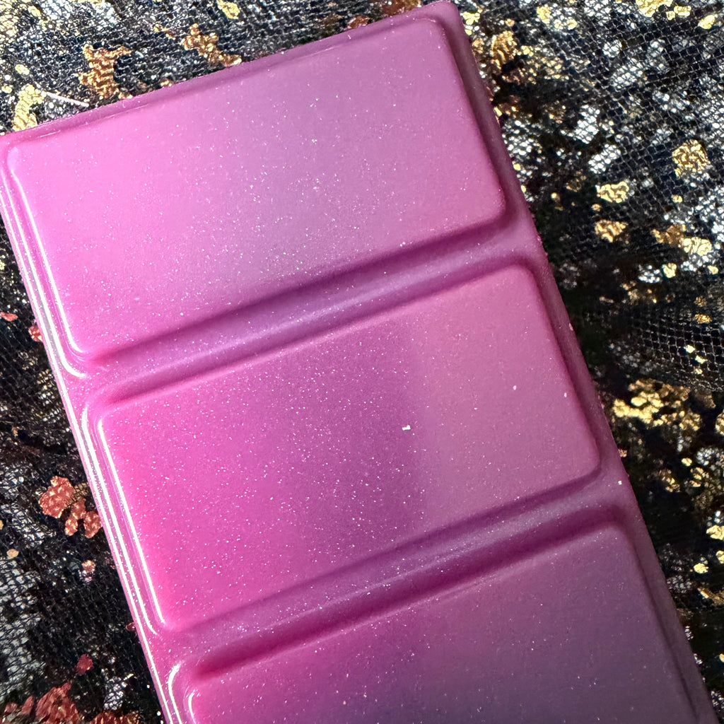 Close-up of the upper Joey wax melt segments, showing the bright pink colour, fine shimmer and a dark charcoal-grey section beginning beneath them.