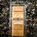 Roary Night gingerbread and vanilla soy wax melt in a clear clamshell, with pale gold wax, gold glitter and a beige label listing ginger, warm spices and vanilla.