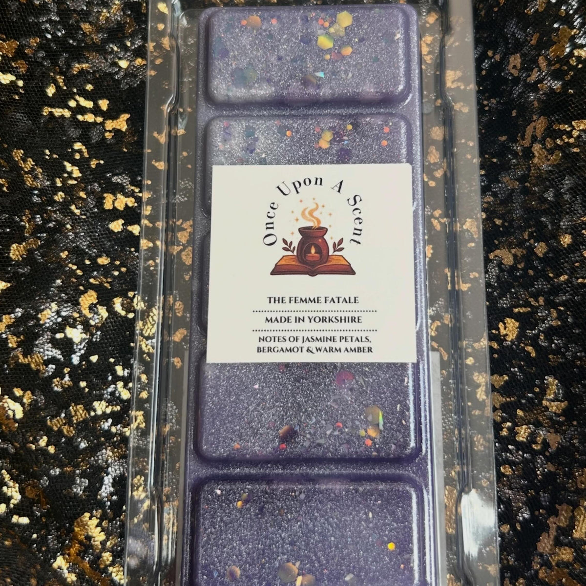 The Femme Fatale fruity floral bookish soy vegan wax melt in a front-facing clamshell showing the Once Upon a Scent label, hand-poured in Yorkshire.