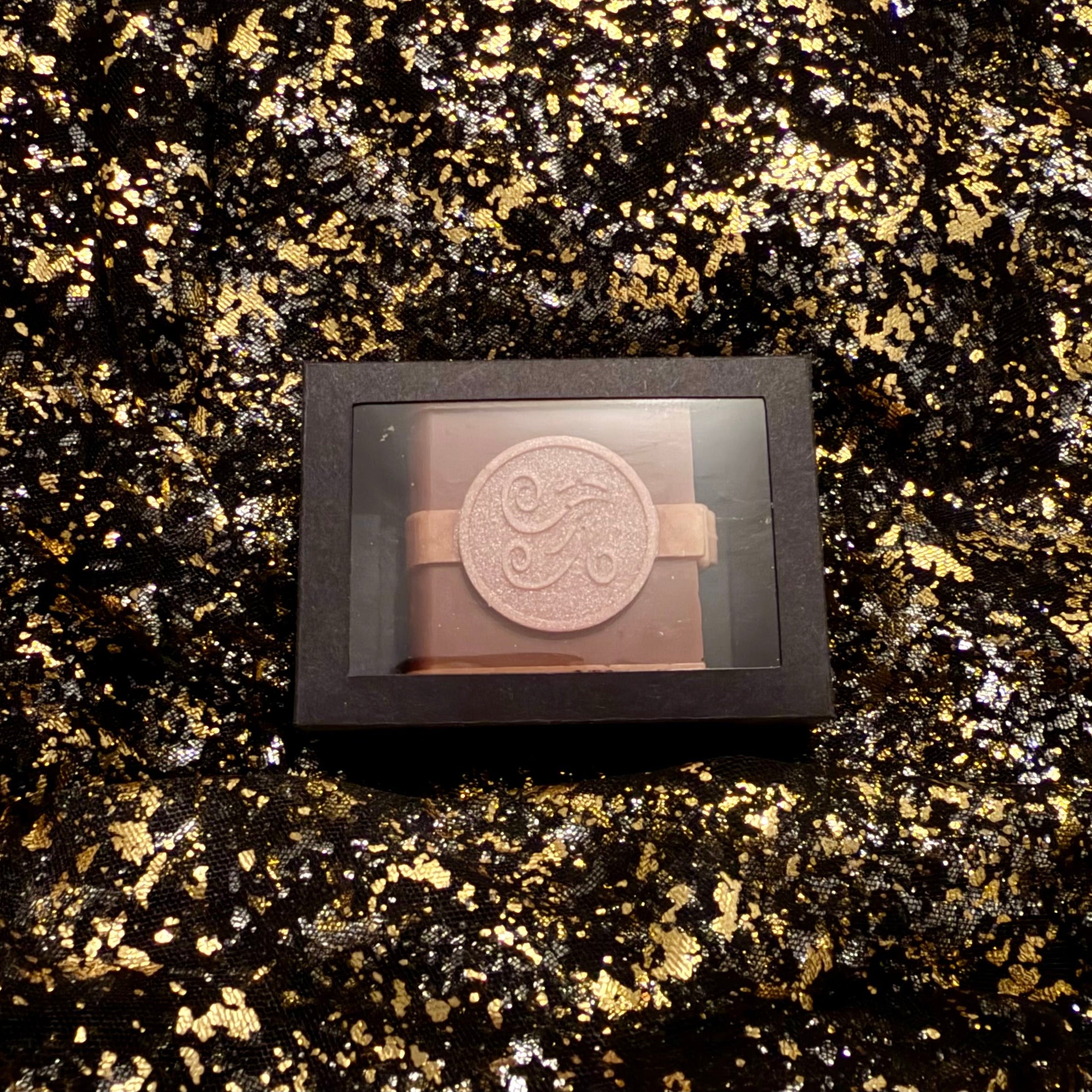 Zodiac Academy Air Element House Aer wax melt in black gift box with swirl embossed spell book design on gold glitter background