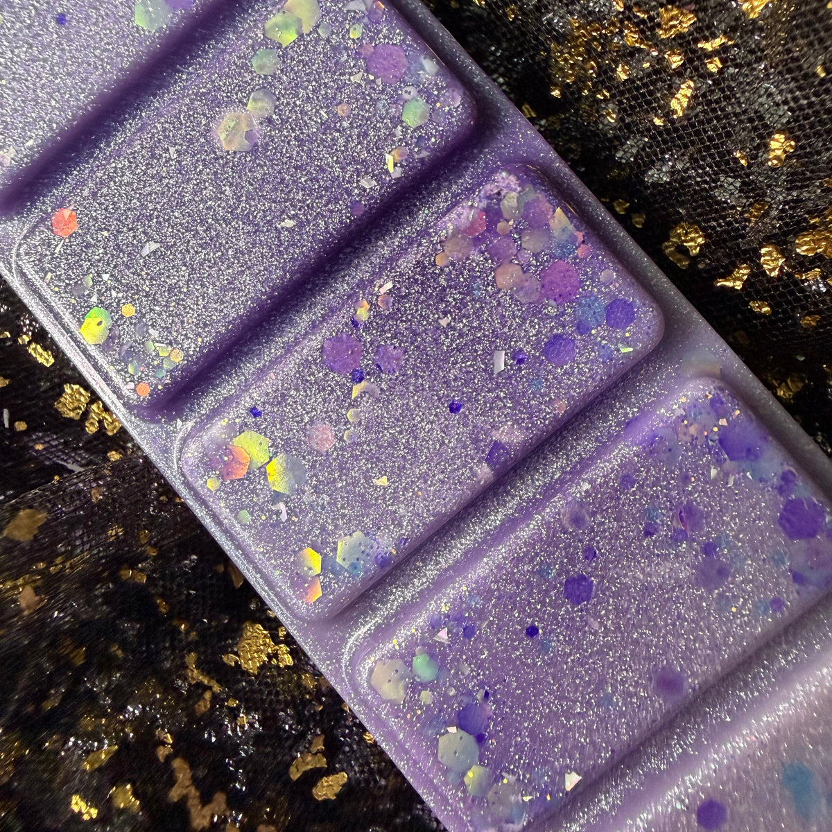 Close-up of The Femme Fatale high-quality soy wax melt showing the wax colour, glitter and decorative finish.