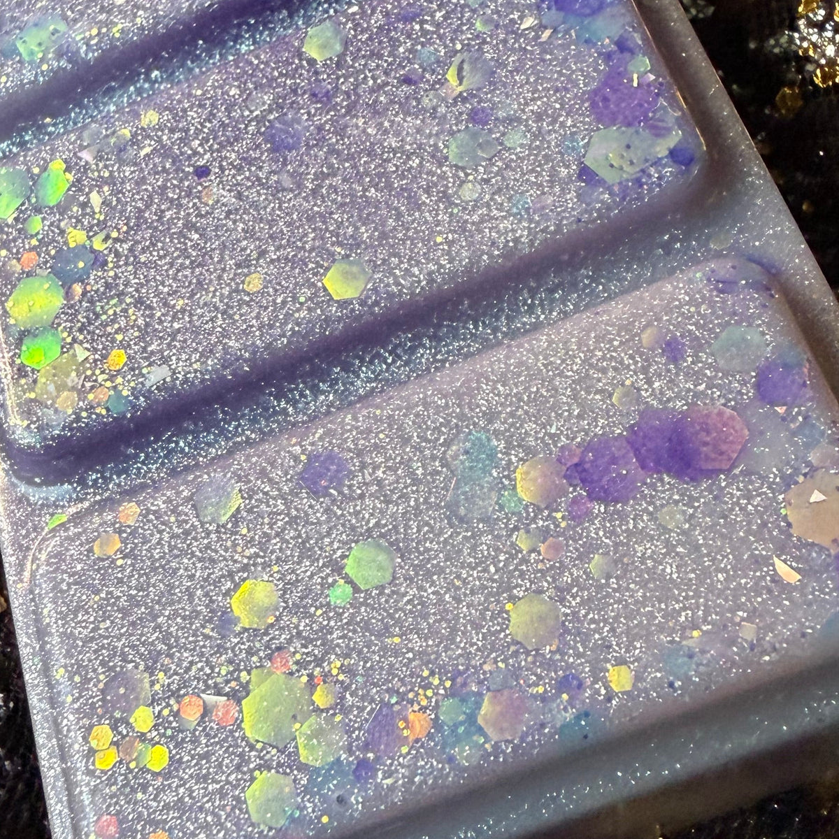 Close-up of The Femme Fatale high-quality soy wax melt showing the wax colour, glitter and decorative finish.
