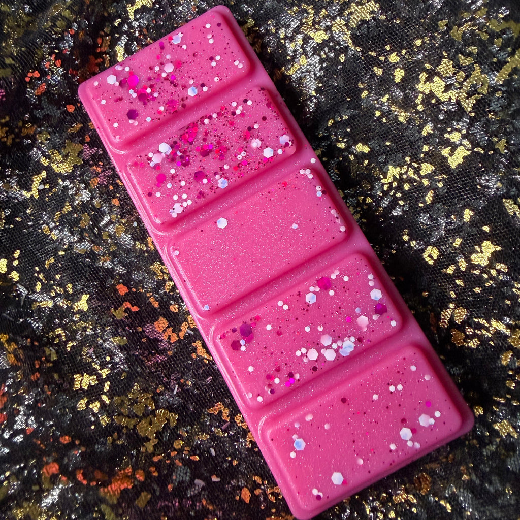 Top view of the Winter Fairy Tale candy floss wax melt clamshell showing the bright pink five-segment wax melt and glitter finish