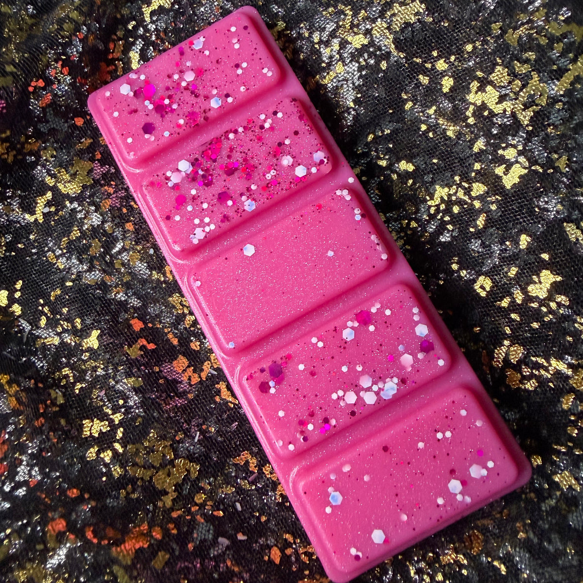 Top view of the Winter Fairy Tale candy floss wax melt clamshell showing the bright pink five-segment wax melt and glitter finish