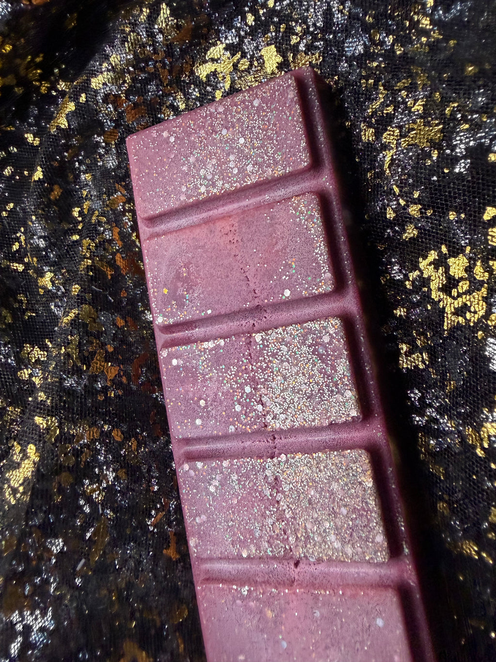Full five-segment Cherry Bomb cherry wax melt with a burgundy colour and sparkling decorative finish. Showing soy frosting on the discounted wax melt. 