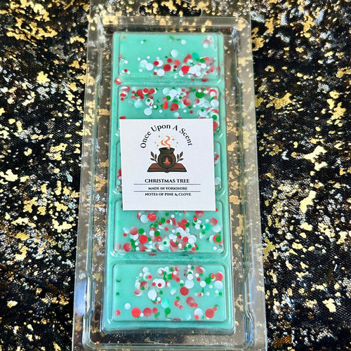 Christmas Tree pine and clove wax melt in a clear clamshell, featuring a mint-green five-segment soy wax bar decorated with red, white and green circular Christmas glitter.
