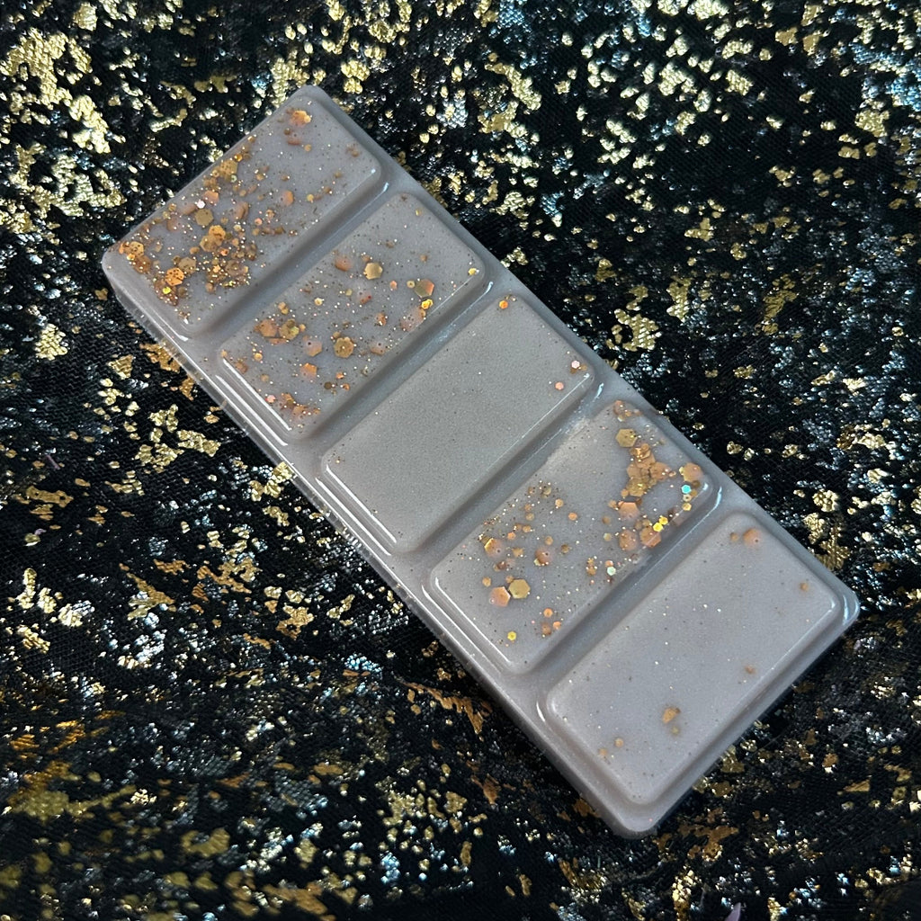 Open clamshell showing The Library highly scented wax melt segments with a woody, musky vintage bookshop fragrance